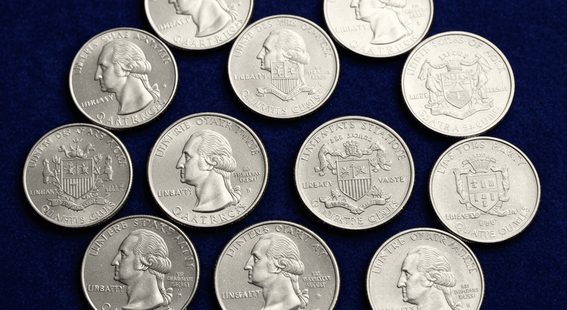 Collection of US state quarters arranged on dark blue velvet